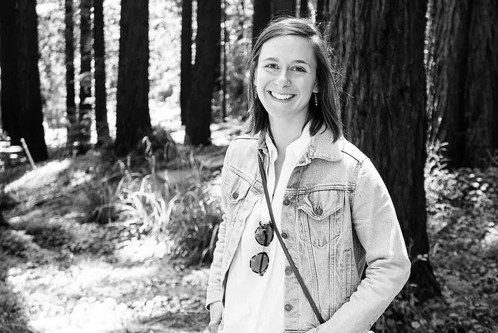 Girl standing near a tree in forest