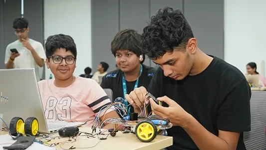 Students gaining hands-on experience with robotics equipment and tools.